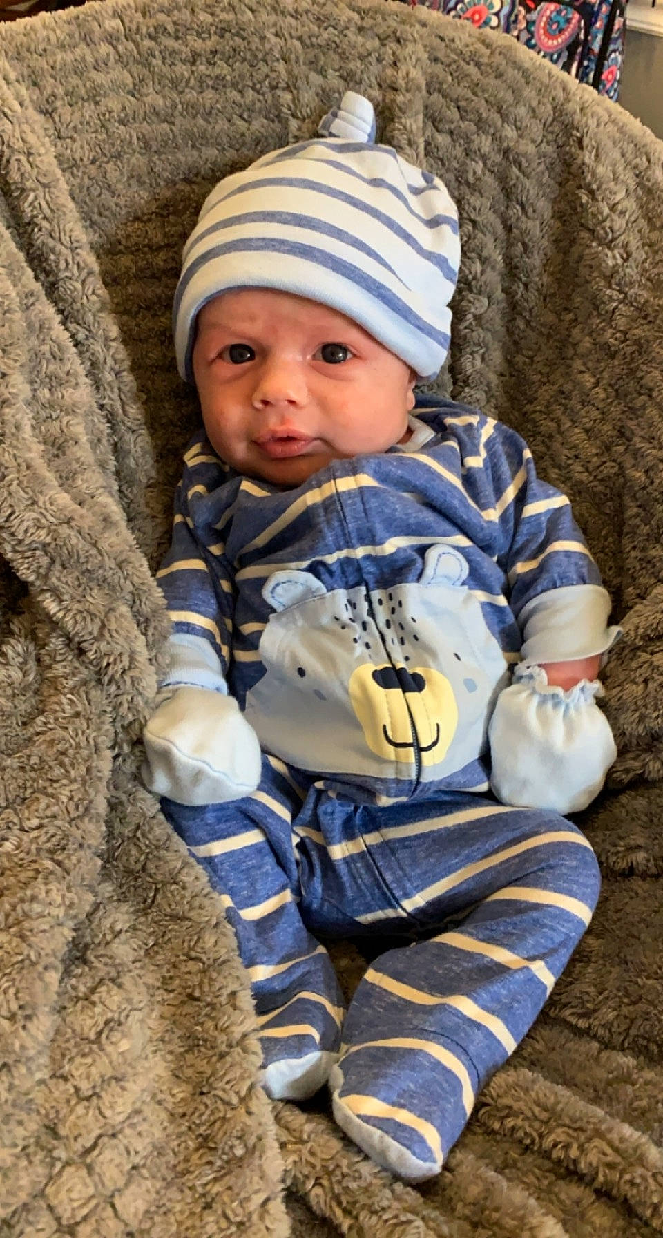 Gatlin is registered to the contest to win money with this photo: baby, baby_toddler_clothing, beanie, cap, child, eye, fun, grass, headgear, headwear, human_body, jacket, knit_cap, outerwear, person, personal_protective_equipment, rock, toddler, tree, vertebrate