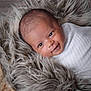 baby, infant, smile, wrapped, blanket, fur, cozy, cute, face, expression, newborn, portrait, closeup, soft, texture, warm, comfort, sleeping_basket, head, person