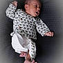 baby, infant, child, lying_down, clothing, shirt, pants, barefoot, foot, hand, face, expression, curious, textile, blanket, pattern, cute, indoors, skin, newborn
