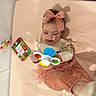 Jade joined the competition — help win amazing prizes! baby, child, toddler, girl, headband, bow, toy, colorful_toy, pink, tutu, clothing, indoor, soft_surface, book, floor, playtime, cute, infant, smiling, exploring