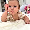 baby, infant, child, toy, phone, bed, bedding, curious, expression, hand, face, ears, clothing, room, indoor, soft, pink, white, cute, portrait