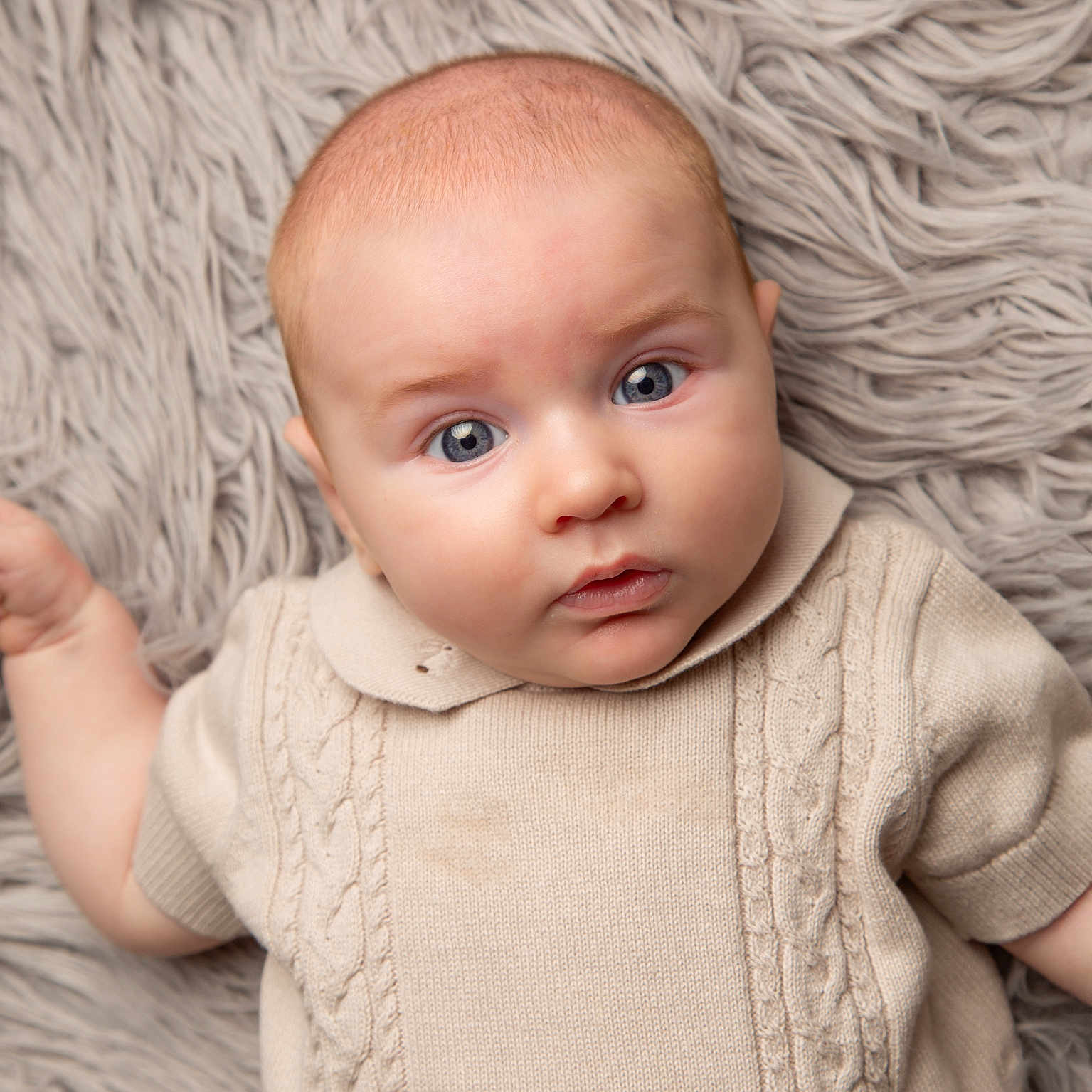Louie is registered to the contest to win money with this photo: baby, bodypart, clothing, face, finger, hand, happy, head, hoodie, knitwear, longsleeve, newborn, pants, person, photography, portrait, sleeve, smile, sweater, sweatshirt