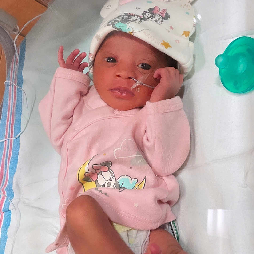 Kaloni joined the competition — help win amazing prizes! awake, baby, bunny_ears, cute, diaper, hat, hospital, hospital_bed, incubator, infant, lying_down, medical_tube, minnie_mouse, monitoring_wires, nasal_tube, newborn, pacifier, person, pink_clothing, small_feet