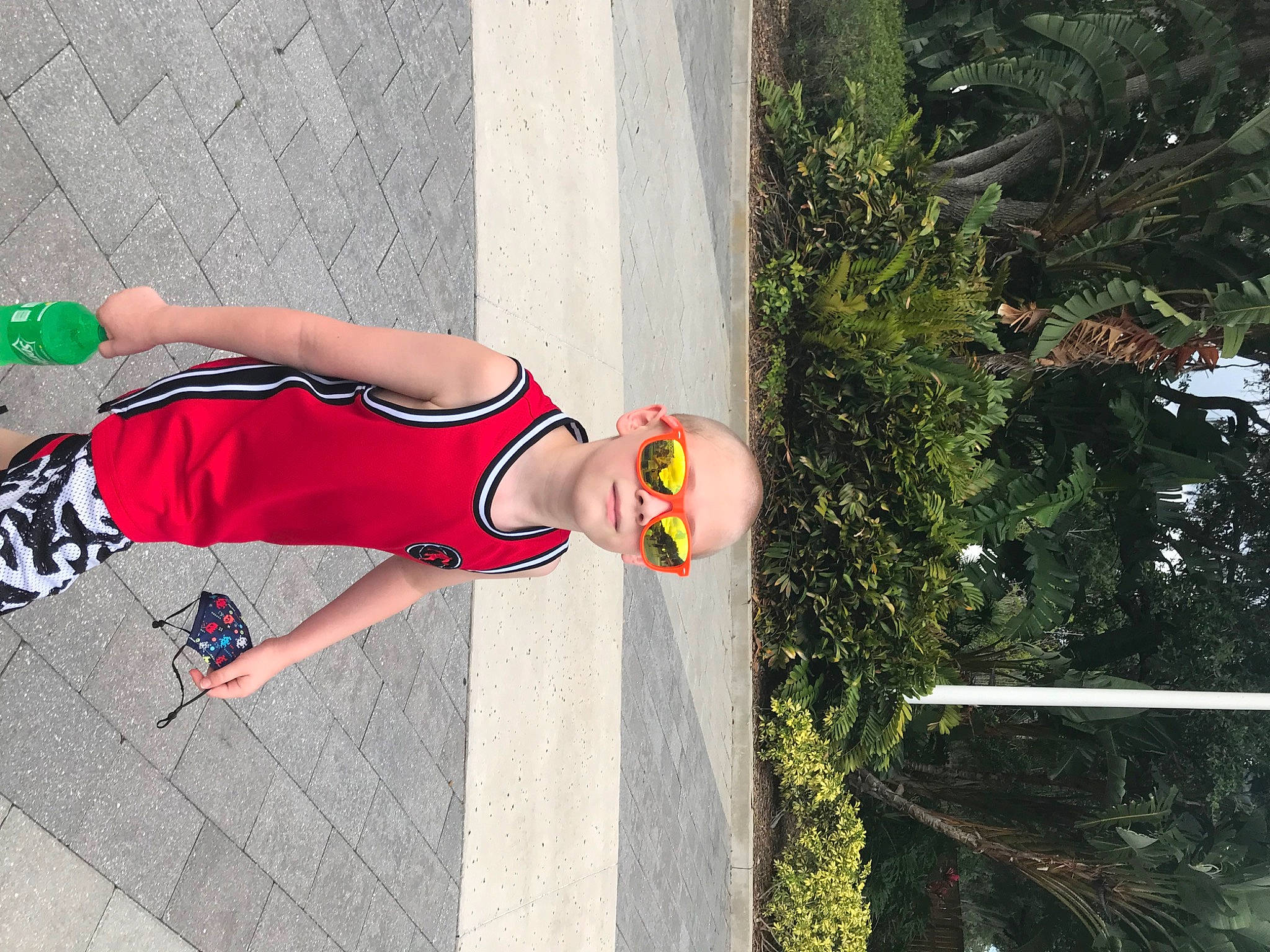 Dustin is registered to the contest to win money with this photo: asphalt, calf, carmine, dress, fun, hat, human_leg, knee, leisure, pedestrian, person, plant, recreation, road, shadow, shorts, sidewalk, thigh, tree, waist