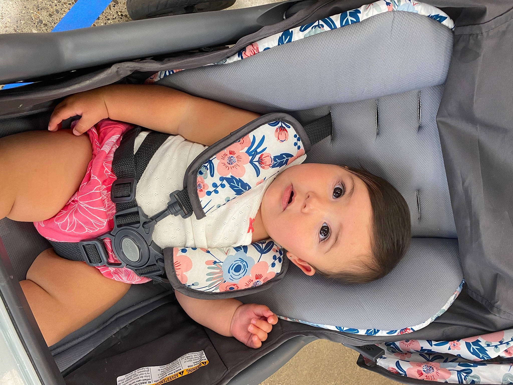 Nakiah is registered to the contest to win money with this photo: auto_part, automotive_design, automotive_exterior, baby, baby_carriage, baby_products, baby_toddler_clothing, car_seat, carmine, comfort, human_leg, knee, lap, leg, motor_vehicle, pattern, person, sitting, surprise, thigh