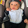 Tavon joined the competition — help win amazing prizes! baby, infant, car_seat, cap, bib, clothing, seatbelt, child, cute, indoors, sitting, portrait, face, headwear, black_clothing, striped_bib, safety, wide_eyes, expression, comfort