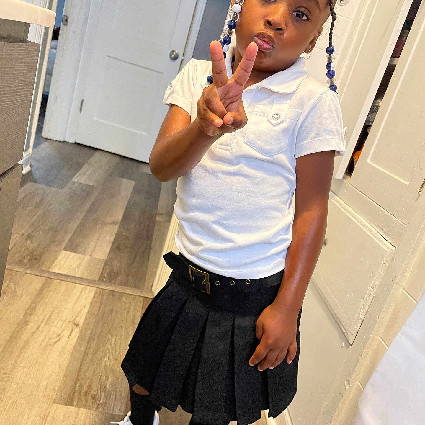 Iniko joined the competition — help win amazing prizes! blackhair, braid, child, clothing, cornrows, dimples, face, female, girl, hair, head, miniskirt, person, shorts, sitting, skirt, sleeve, standing, student, surprised