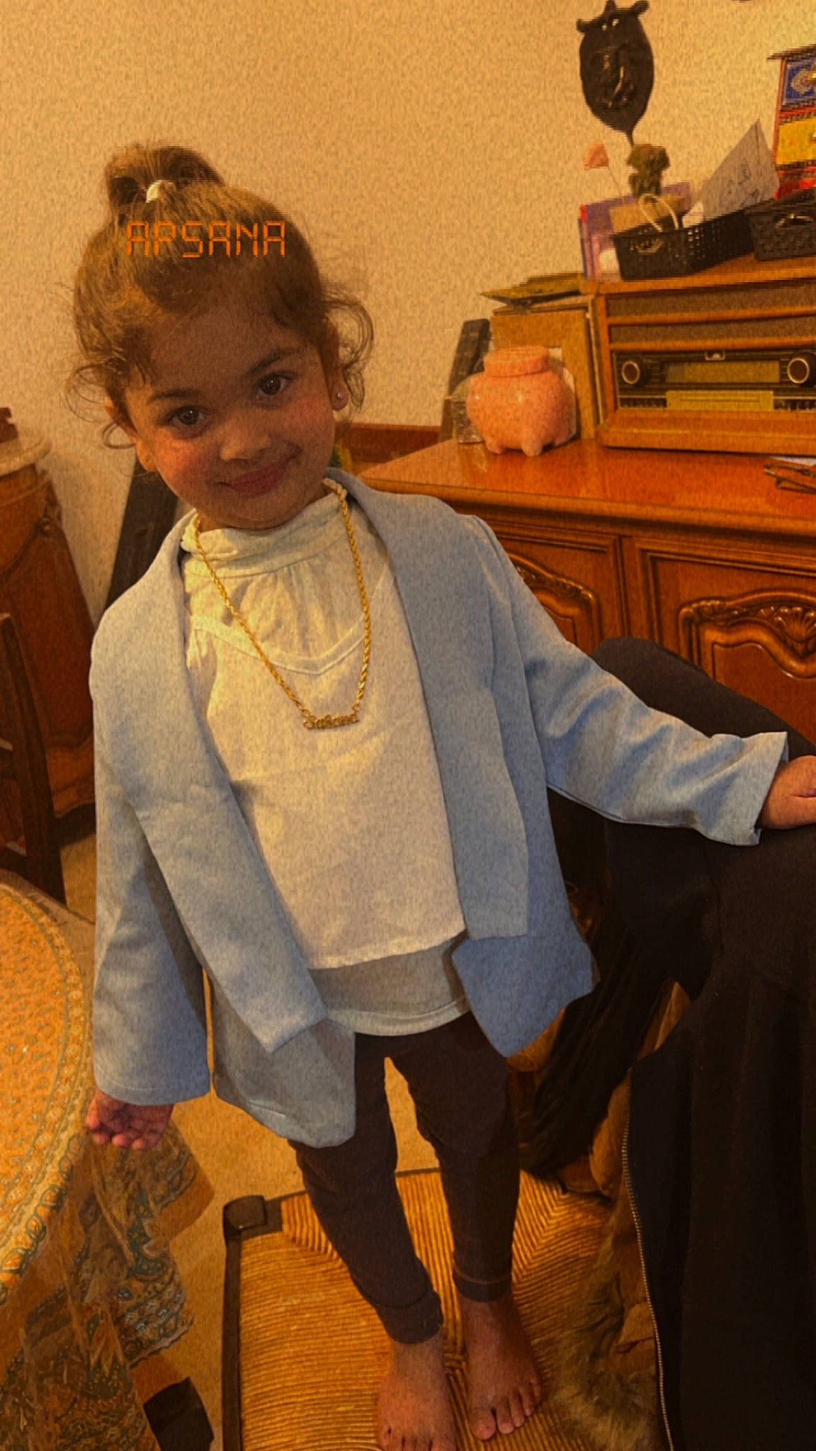 Sahana participe au concours pour gagner de l'argent avec cette photo : art, cabinetry, chest_of_drawers, child, drawer, dress, fashion_accessory, fashion_design, flooring, formal_wear, hair, hairstyle, head, jewellery, joy, outerwear, person, room, sitting, sleeve