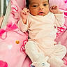Jeriha is registered to the contest to win money with this photo: baby, infant, pink_blanket, onesie, slippers, cute, newborn, face, hands, feet, lying_down, soft_toys, social_media, reaction_icons, text_overlay, heart_emoji, love, sleepwear, portrait, indoor