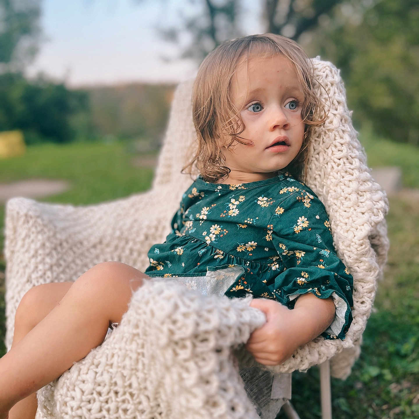 Kinsley is registered to the contest to win money with this photo: armchair, beachwear, blanket, blonde, chair, child, clothing, dress, face, female, furniture, girl, hair, happy, head, person, photography, portrait, sitting, smile