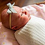 Arabella joined the competition — help win amazing prizes! newborn, baby, infant, headband, bow, blanket, pink_pillow, flower_pattern, sleeping, resting, closeup, portrait, soft_light, indoors, cute, wrapped, child, baby_girl, peaceful, cozy