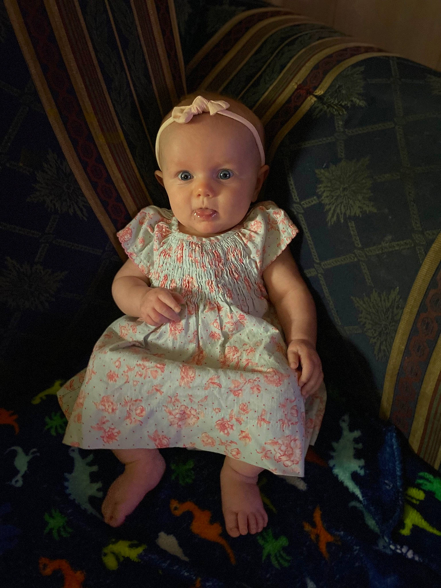 Emmaline joined the competition — help win amazing prizes! baby, baby_toddler_clothing, cheek, child, comfort, couch, day_dress, flash_photography, flooring, foot, fun, grass, human_body, human_leg, pattern, person, room, sitting, tints_and_shades, toddler