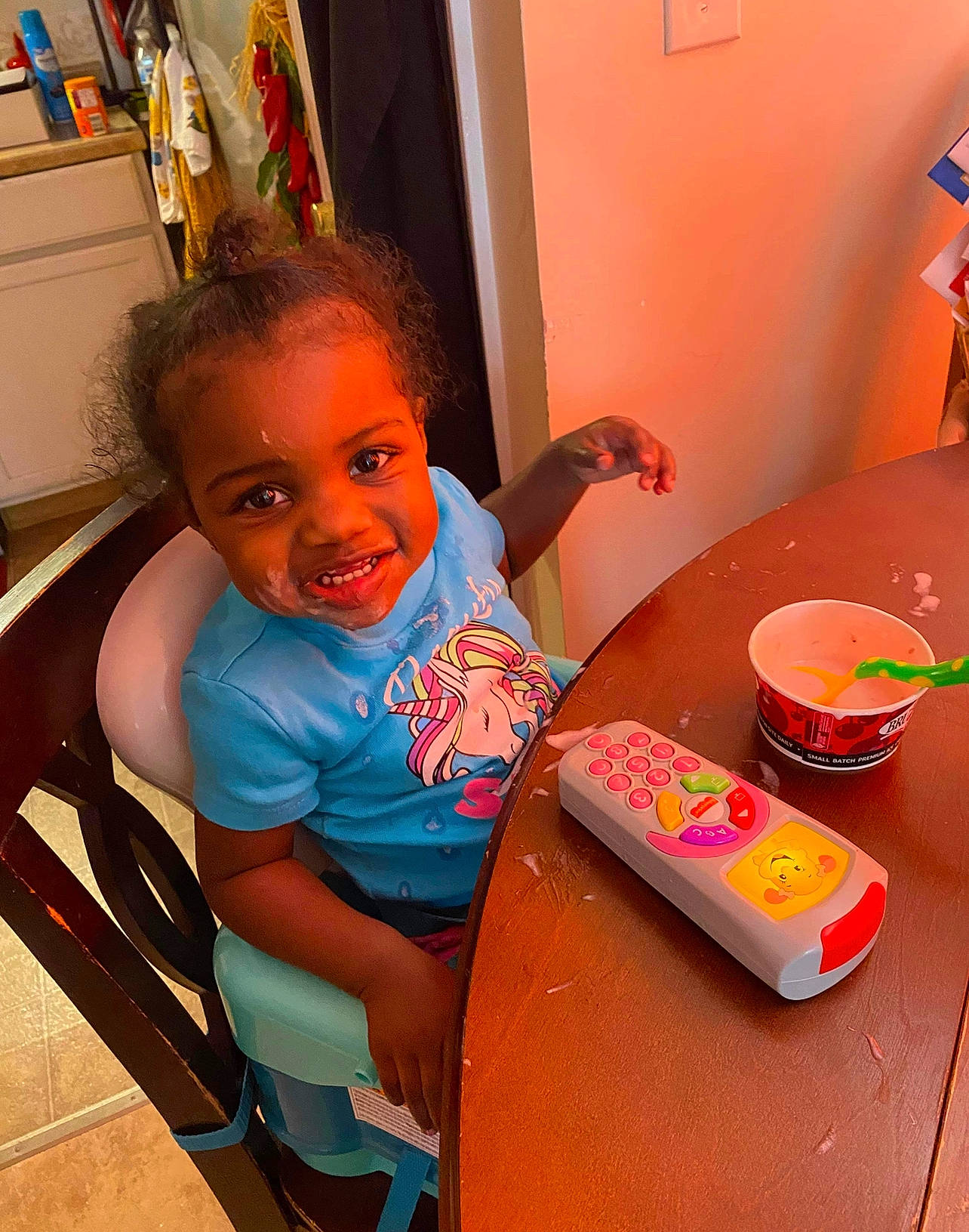Tylah joined the competition — help win amazing prizes! baby, baby_playing_with_toys, baby_toddler_clothing, breakfast, chair, child, food, fun, happy, joy, leisure, orange, person, picture_frame, play, room, sitting, smile, table, tableware