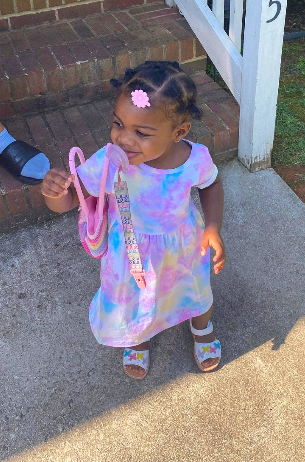 Tylah is registered to the contest to win money with this photo: baby_toddler_clothing, child, electric_blue, fence, fun, grass, happy, hat, leisure, magenta, pattern, person, pink, play, purple, recreation, shoe, sleeve, smile, t_shirt