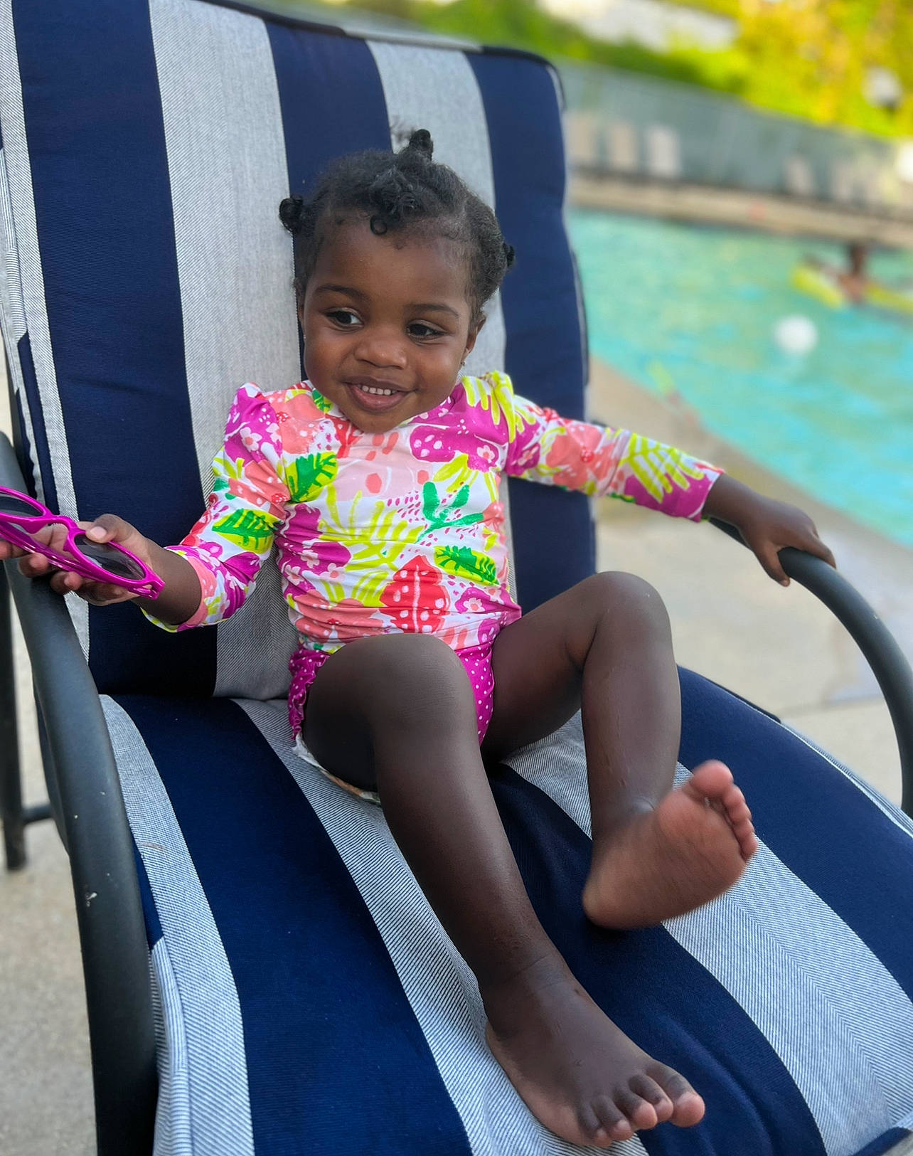 Tylah is registered to the contest to win money with this photo: baby_toddler_clothing, barefoot, boats_and_boating_equipment_and_supplies, child, eye, finger, fun, happy, human_body, human_leg, joy, leg, leisure, person, public_space, recreation, sitting, smile, summer, thigh