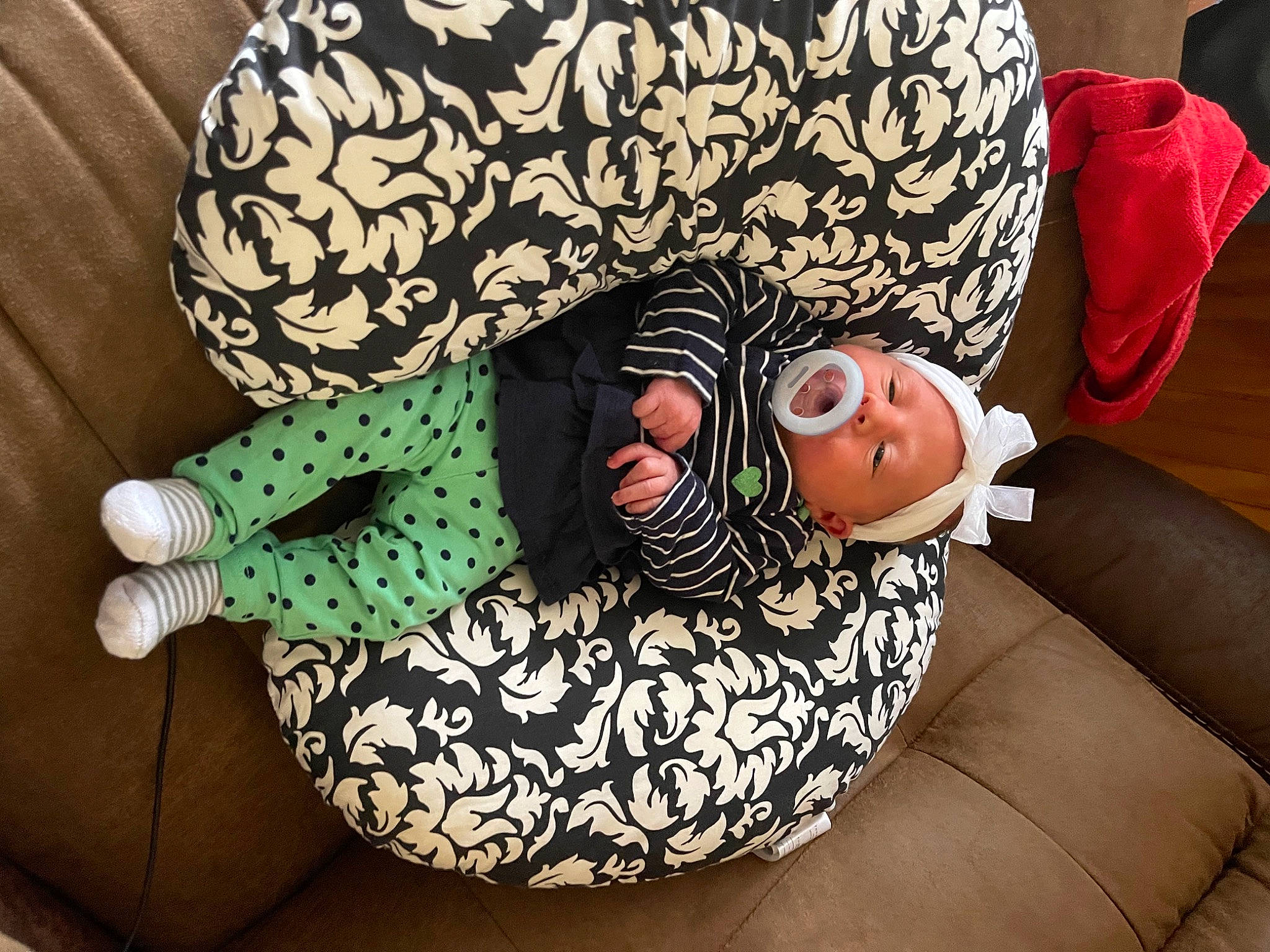 Kaylin is registered to the contest to win money with this photo: baby, baby_products, baby_sleeping, baby_toddler_clothing, child, comfort, couch, happy, human_leg, lap, leg, linens, pattern, person, room, sitting, sleeve, sock, textile, thigh