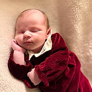 Ayda is registered to the contest to win money with this photo: baby, sleeping, infant, blanket, soft_texture, burgundy_clothing, white_collar, peaceful, portrait, closeup, newborn, cute, child, resting, cozy, warm, indoors, skin, face, hand