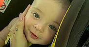 Graysen joined the competition — help win amazing prizes! baby, child, car_seat, hand, manicure, smile, face, infant, seatbelt, safety, yellow_clothing, close_up, portrait, indoors, cute, person, skin, head, eyes, baby_carrier