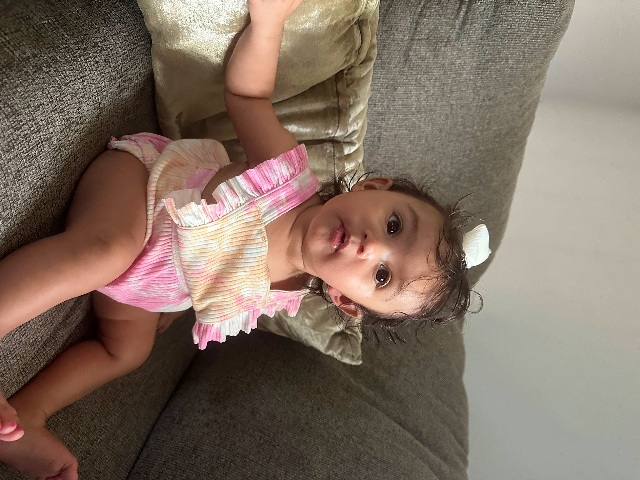 Jasmine is registered to the contest to win money with this photo: baby, baby_toddler_clothing, chair, cheek, chest, child, comfort, foot, fun, human_leg, joint, knee, linens, magenta, mouth, person, sitting, skin, sock, surprise