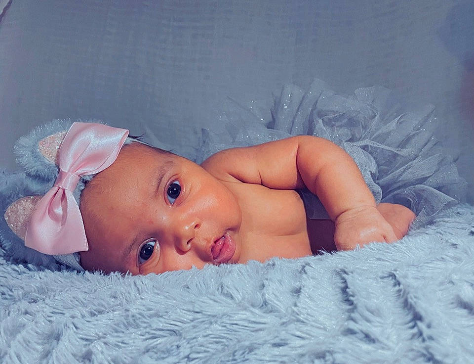 Avaya is registered to the contest to win money with this photo: baby, baby_toddler_clothing, cheek, cloud, comfort, eye, eyebrow, eyelash, facial_expression, grass, hand, head, headgear, human_body, iris, lip, mouth, nose, person, skin