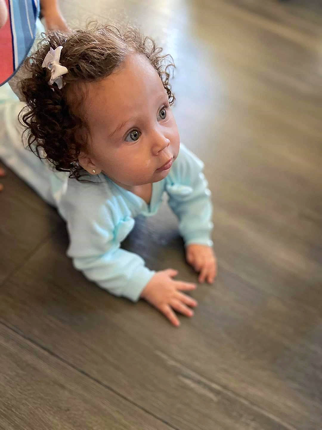 Gisella is registered to the contest to win money with this photo: arm, baby, cheek, child, crawling, eye, finger, floor, flooring, fun, hand, hardwood, leg, nose, person, photography, skin, standing, surprise, toddler