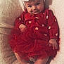 baby, infant, child, red_dress, tutu_skirt, headband, bow, socks, blanket, smile, cute, portrait, indoors, soft_texture, happy, sitting, face, person, clothing, cozy