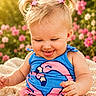Ember joined the competition — help win amazing prizes! baby, child, blonde_hair, pigtails, pink_hair_clips, blue_outfit, flamingo_design, tongue_out, smiling, sitting, blanket, flowers, pink_flowers, outdoor, sunlight, greenery, nature, cute, happy, portrait