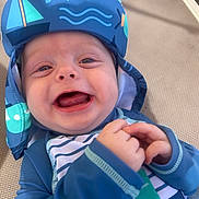 Edison joined the competition — help win amazing prizes! baby, child, smiling, blue_hat, striped_clothing, outdoor, happy, infant, sun_hat, closeup, face, hands, playful, cute, joyful, person, apparel, pattern, texture, light