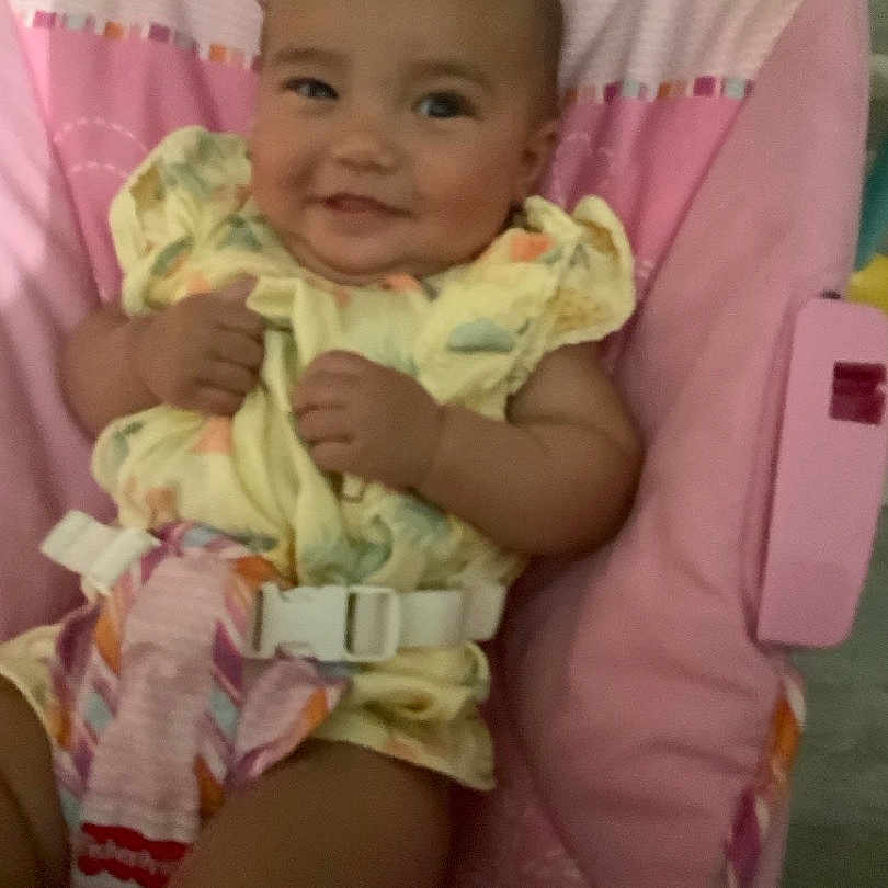 Yasmine joined the competition — help win amazing prizes! baby, baby_girl, child, clothing, comfort, cushion, cute, fabric, happy, indoors, infant, patterned_clothing, person, pink, portrait, seat, smiling, soft, straps, toddler