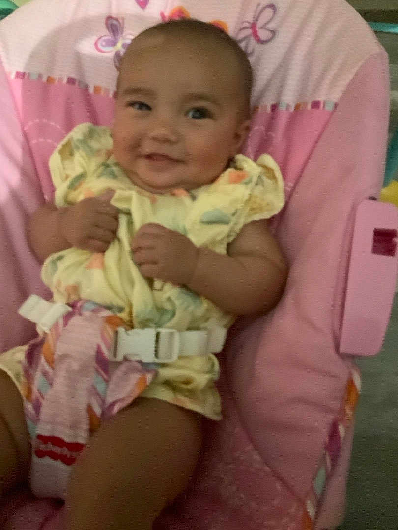 Yasmine joined the competition — help win amazing prizes! baby, smiling, infant, child, pink, seat, cushion, clothing, straps, happy, portrait, indoors, cute, toddler, person, baby_girl, soft, comfort, fabric, patterned_clothing