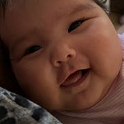 Jolene is registered to the contest to win money with this photo: baby, face, smile, cheeks, infant, closeup, happy, child, skin, clothing, person, indoors, cute, young, head, portrait, expression, soft, hand, warm