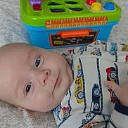 Corbin joined the competition — help win amazing prizes! baby, infant, toy, colorful, plastic, workbench, onesie, car_pattern, blanket, face, child, lying_down, curious_eyes, indoor, playtime, early_childhood, cute, baby_clothes, soft_lighting, background