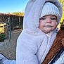 Elsie joined the competition — help win amazing prizes! baby, child, hoodie, white, hat, knit, cold_weather, outdoor, garden, path, fence, blue_sky, person, warm_clothing, cute, face, portrait, cozy, infant, holding
