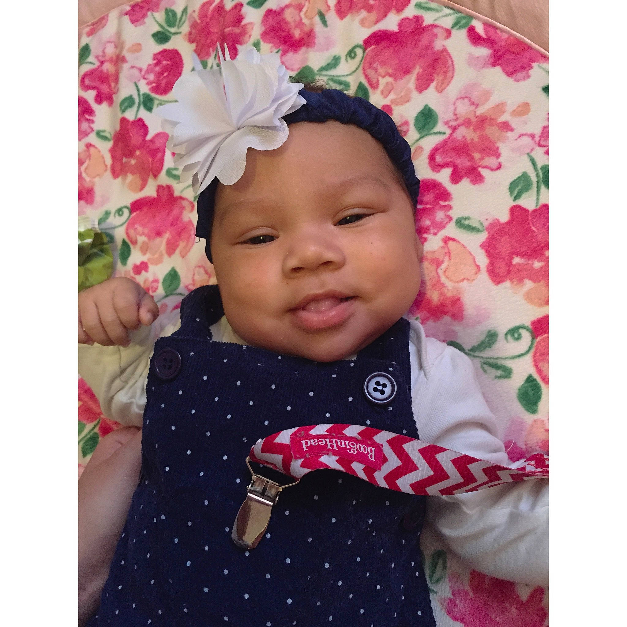 Emire is registered to the contest to win money with this photo: baby, baby_toddler_clothing, beauty, cap, collar, dress, face, flower, font, happy, headwear, lip, magenta, pattern, person, petal, pink, skin, sleeve, smile