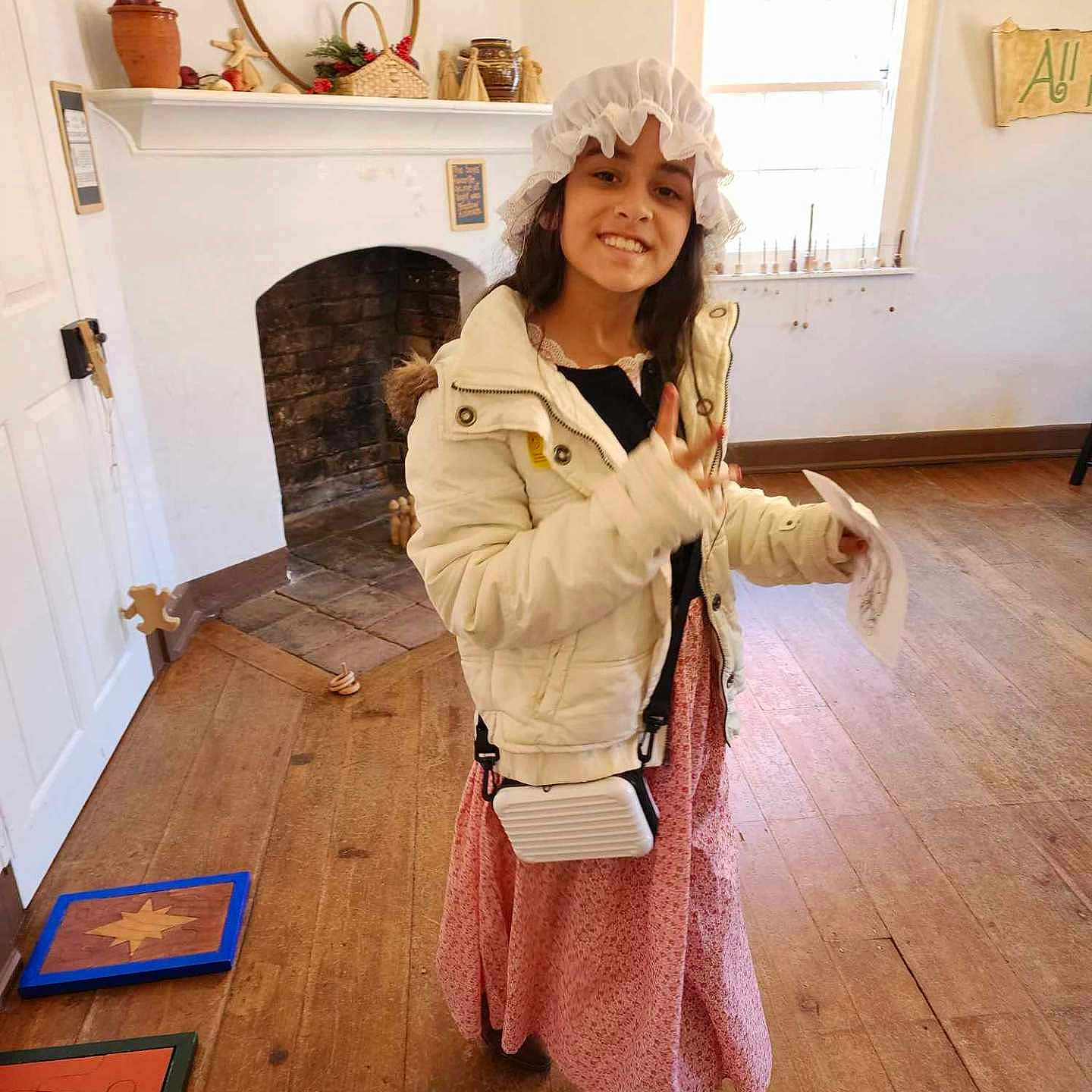 Lydia Cook is registered to the contest to win money with this photo: adult, blonde, clothing, coat, costume, curlyhair, face, female, fireplace, hair, hardwood, head, indoors, lady, person, photography, sleeve, wig, woman, wood