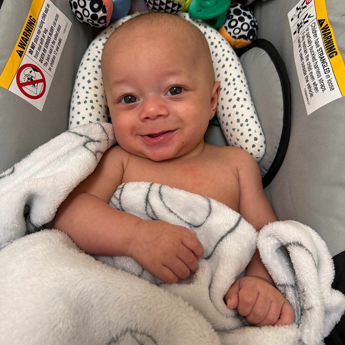 Dawson joined the competition — help win amazing prizes! baby, baby_seat, blanket, child, comfort, cozy, cute, expression, face, hand, head, indoor, infant, person, plush_toy, skin, smile, toy, warning_label, wrapped