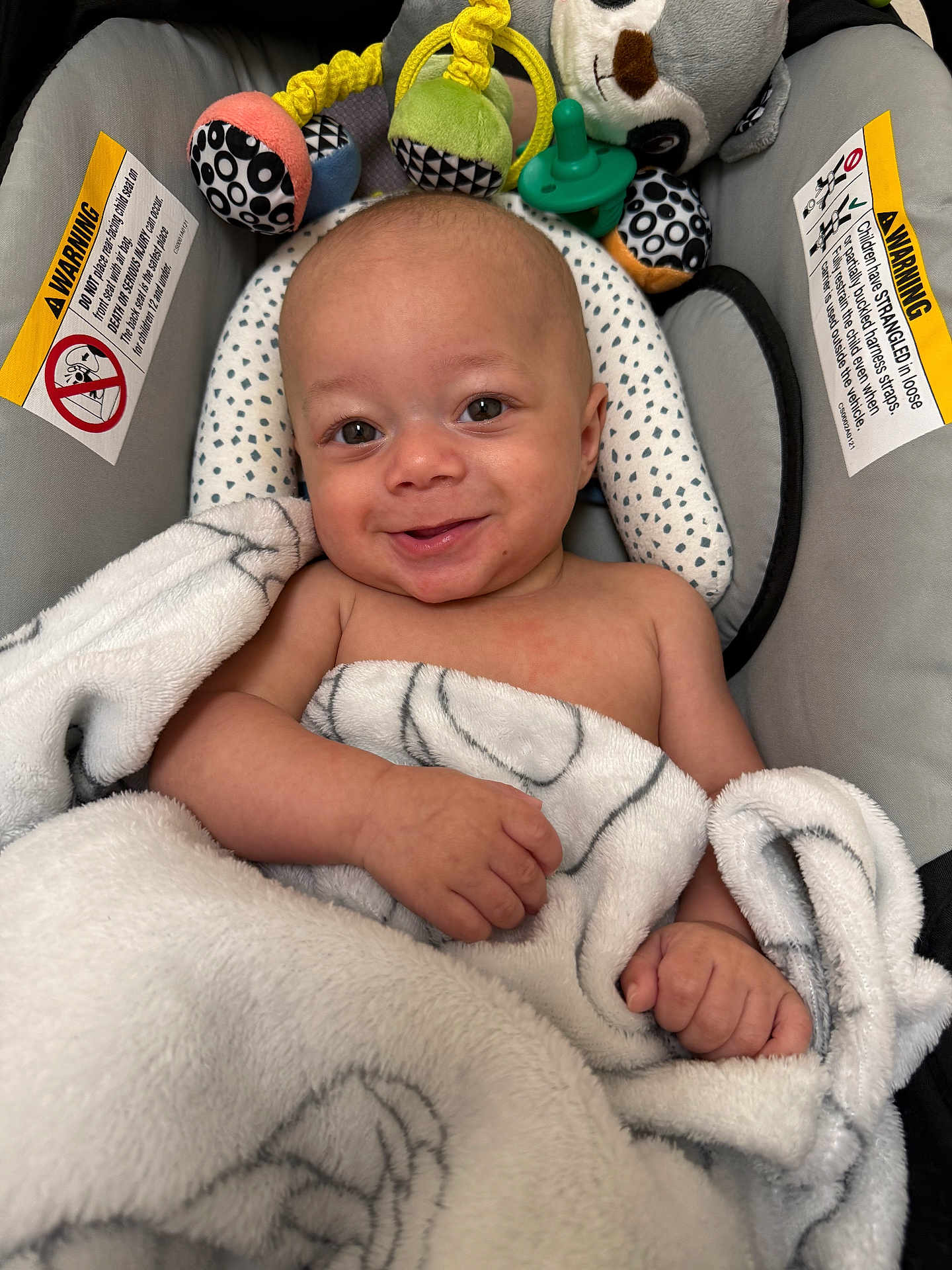 Dawson joined the competition — help win amazing prizes! baby, blanket, smile, infant, baby_seat, toy, plush_toy, warning_label, face, hand, cozy, comfort, child, cute, indoor, person, skin, head, expression, wrapped