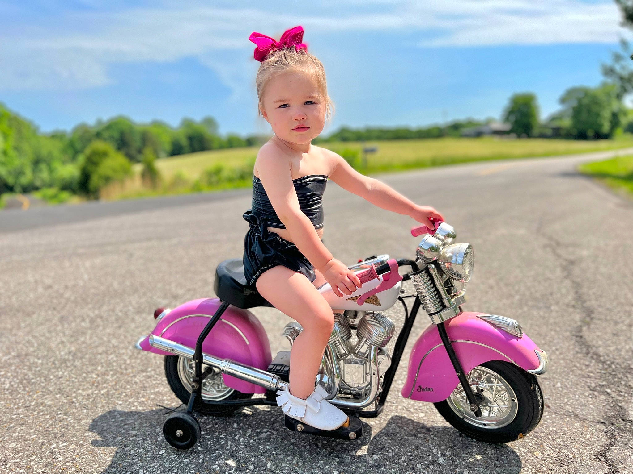 Ruby Cate is registered to the contest to win money with this photo: automotive_design, automotive_lighting, automotive_tire, cloud, dress, fender, grass, happy, hat, helmet, land_vehicle, motor_vehicle, person, pink, plant, rolling, sky, tire, tree, vehicle