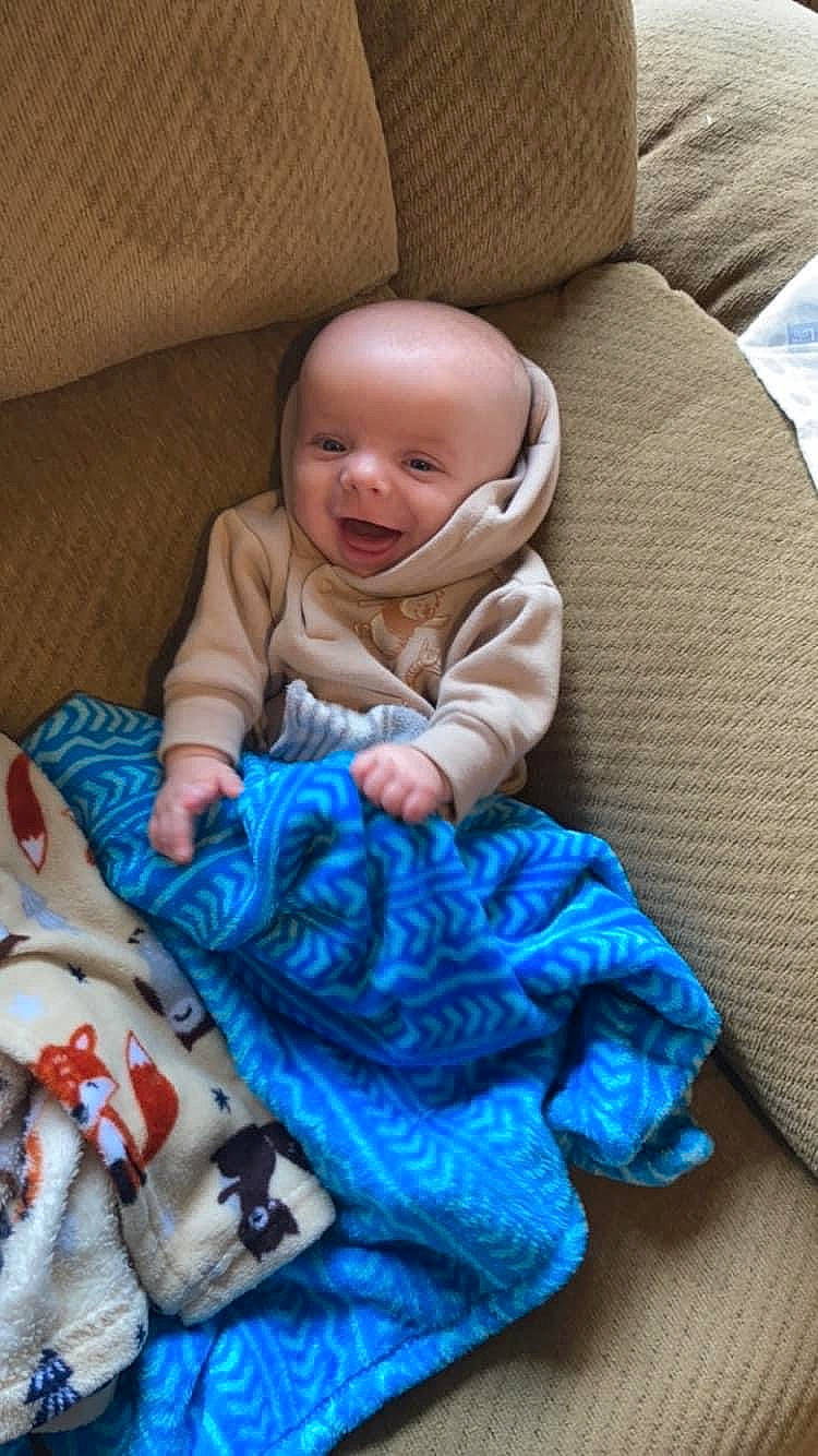 Ryker joined the competition — help win amazing prizes! baby, baby_products, baby_sleeping, baby_toddler_clothing, cheek, child, comfort, electric_blue, iris, linens, person, product, room, sitting, skin, sleeve, smile, textile, toddler, wool