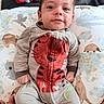animal_pattern, baby, baby_boy, baby_girl, child, comfort, cute, eyes, face, hand, indoor, infant, onesie, pillow, portrait, smile, striped_clothing, tiger_design, toy, young_child