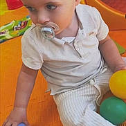 Kayden a rejoint le concours — aidez-le/la à gagner de superbes lots ! toddler, child, pacifier, ball, play_mat, indoor_playground, toy, orange_mat, white_clothing, striped_pants, sitting, cute, playtime, young_child, baby, colorful, hand, skin, face, short_hair