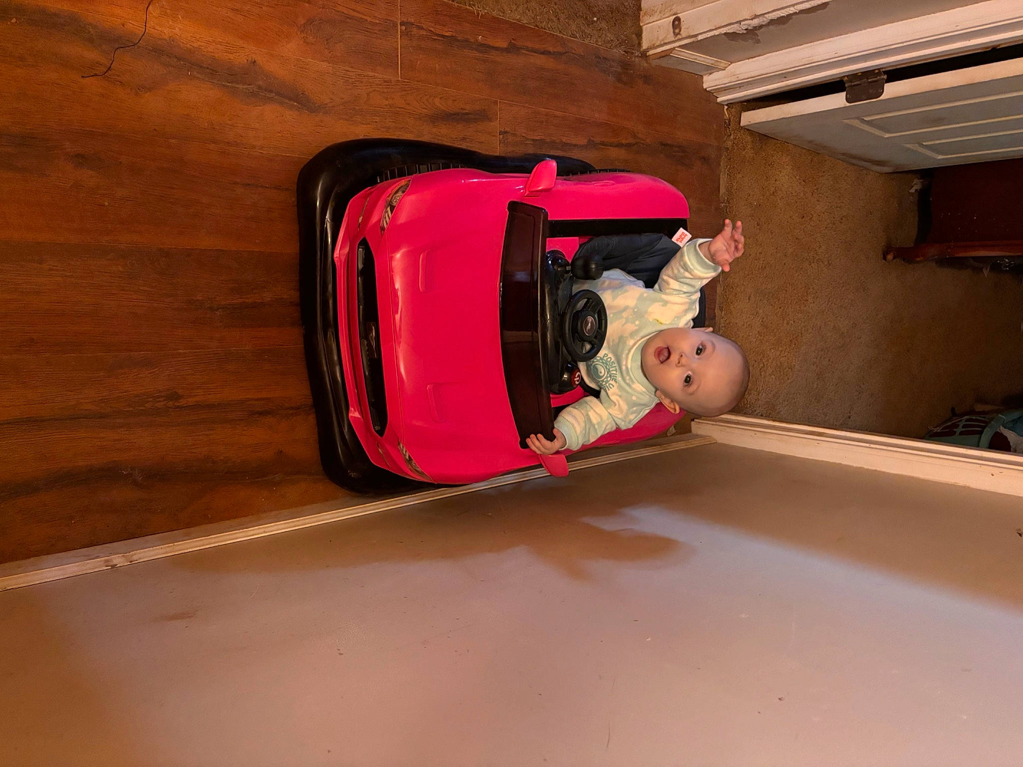 Phoenix is registered to the contest to win money with this photo: auto_part, automotive_design, automotive_exterior, automotive_lighting, bumper, flooring, fun, hardwood, hood, luxury_vehicle, machine, motor_vehicle, person, room, surprise, tints_and_shades, toddler, vehicle, vehicle_door, window