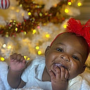 Zariyah is registered to the contest to win money with this photo: accessories, baby, bodypart, clothing, couch, face, finger, hand, happy, hat, head, laughing, lighting, mouth, newborn, person, photography, portrait, smile, teeth