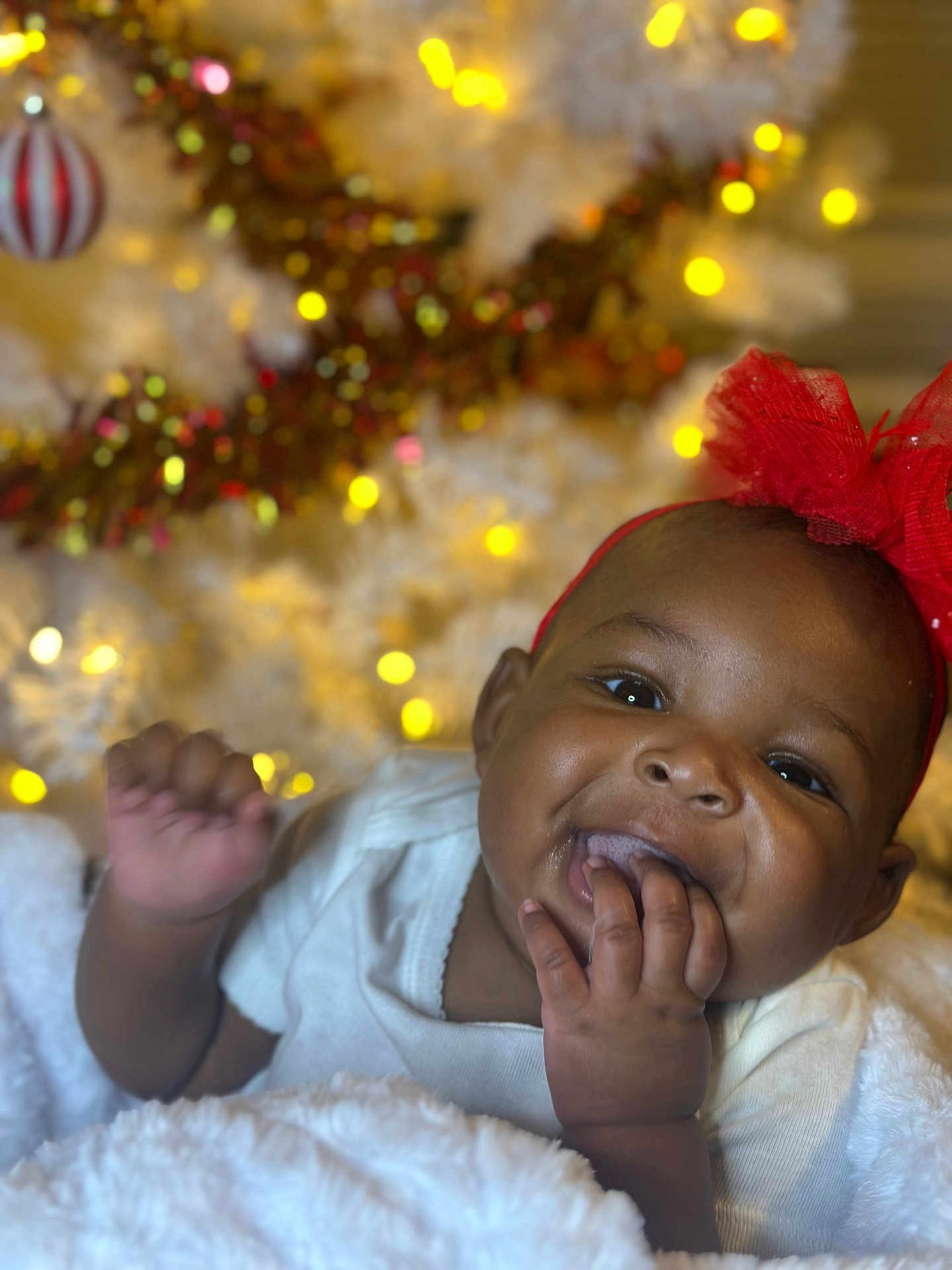 Zariyah is registered to the contest to win money with this photo: accessories, baby, bodypart, clothing, couch, face, finger, hand, happy, hat, head, laughing, lighting, mouth, newborn, person, photography, portrait, smile, teeth