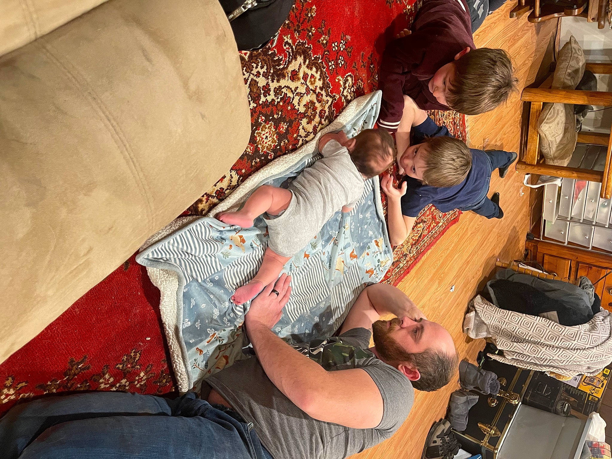 Jerremiah is registered to the contest to win money with this photo: bag, black_hair, comfort, couch, fashion_design, fun, hat, human_leg, lap, leisure, luggage_and_bags, office_equipment, office_supplies, pattern, person, room, sitting, t_shirt, textile, travel