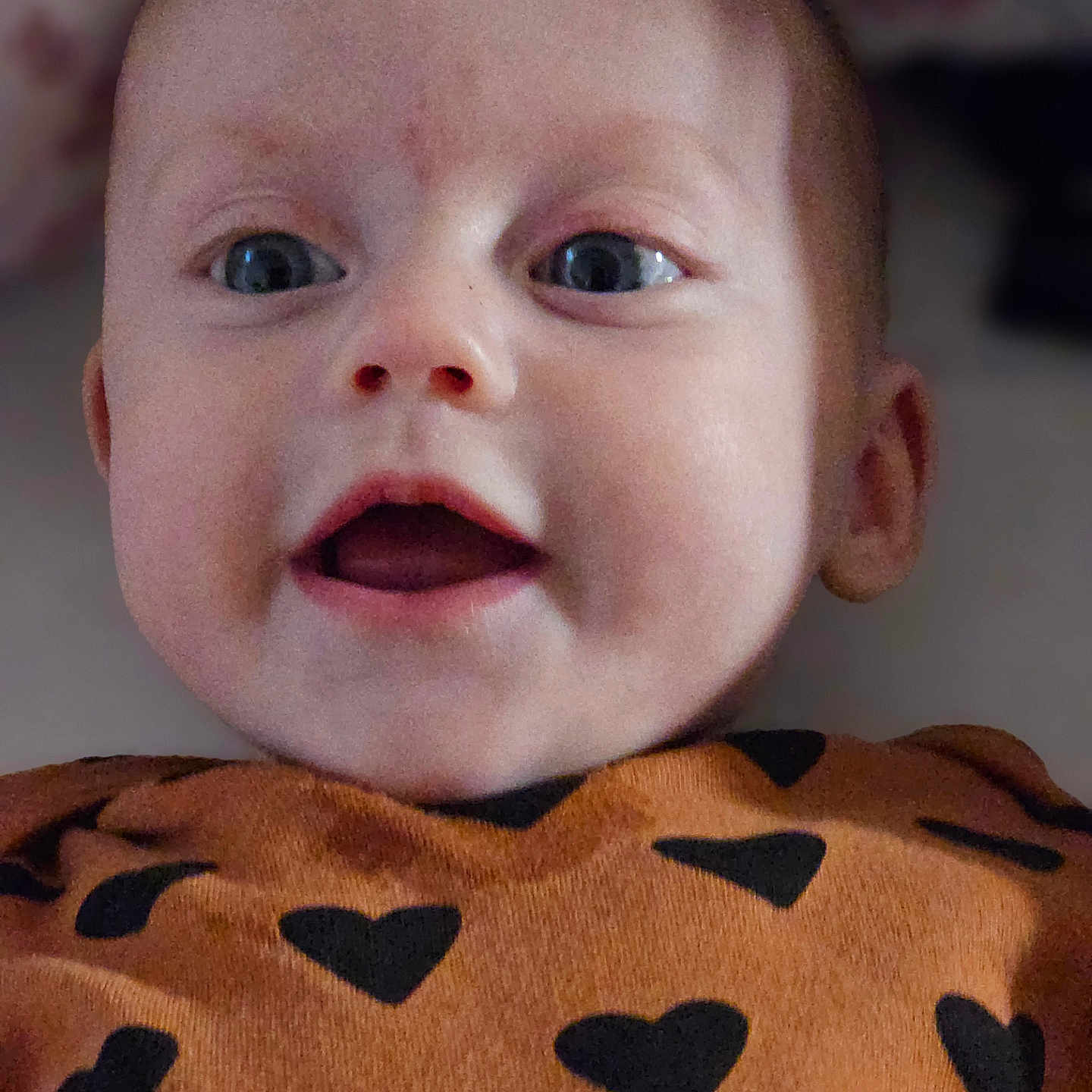 Aurora is registered to the contest to win money with this photo: adorable, baby, child, closeup, clothing, cute, expression, eyes, face, happy, head, heart_pattern, indoors, infant, mouth, person, portrait, skin, smiling, young