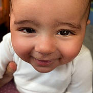 Elysia is registered to the contest to win money with this photo: baby, child, close_up, cute, expression, eyes, face, happy, head, indoor, infant, person, pink_pants, polka_dot, portrait, rosy_cheeks, skin, smile, white_clothing, young_child