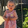 Lilas participe au concours pour gagner de l'argent avec cette photo : toddler, child, girl, blue_eyes, pink_dress, floral_pattern, standing, outdoor, wooden_bridge, net_fence, sunlight, daylight, hands_clasped, portrait, young_child, curious, cute, summer_clothing, nature, background_blur