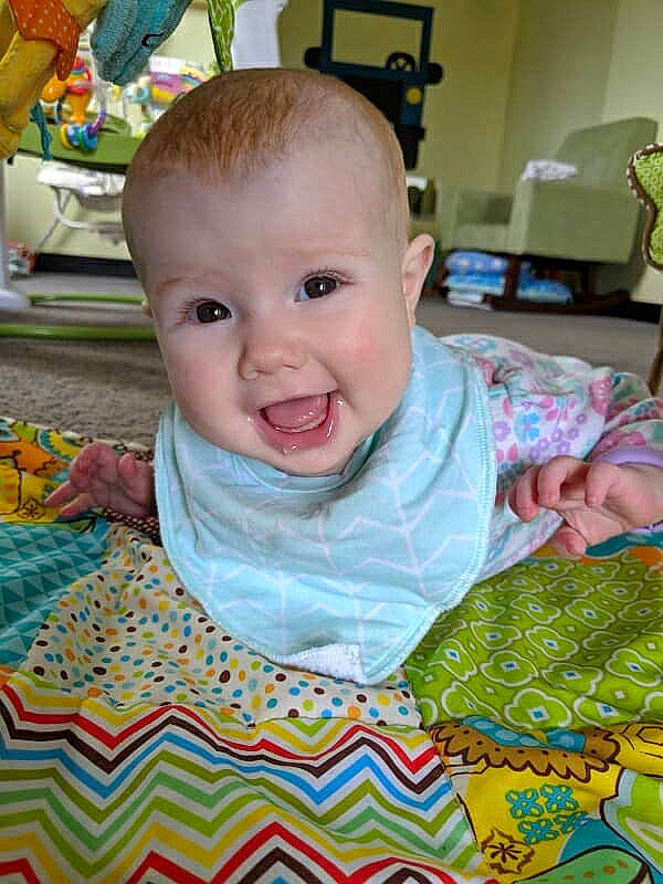 Cordelia joined the competition — help win amazing prizes! art, baby, baby_toddler_clothing, blanket, cheek, child, face, joy, linens, nap_mat, person, play, quilt, room, sitting, skin, smile, textile, toddler, tummy_time