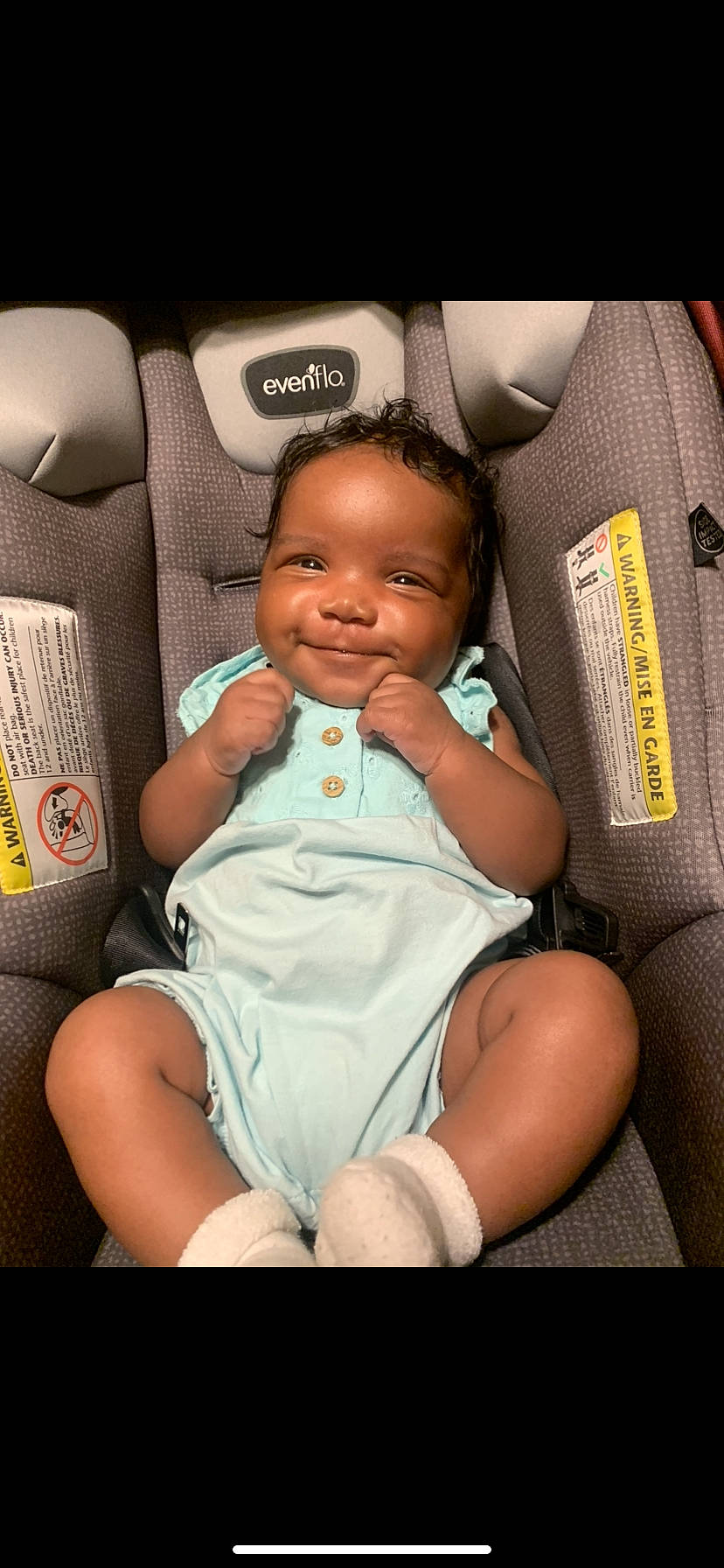 Novah is registered to the contest to win money with this photo: auto_part, baby, baby_products, baby_toddler_clothing, car_seat, cheek, child, comfort, finger, flash_photography, happy, human_leg, joy, knee, nail, person, sitting, skin, smile, thigh